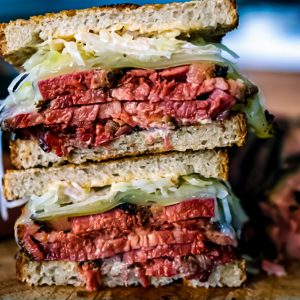 Beauregard’s Pastrami Reuben sandwich with house-smoked pastrami, melted Jarlsberg cheese, house-made sauerkraut, and tangy Russian-style dressing on rye bread.